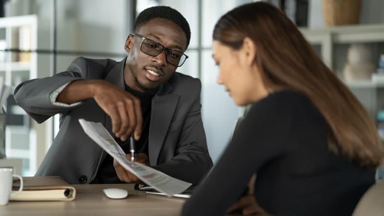 A certified public accountant (CPA) reviews financial documents with a customer.