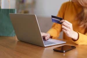 Woman reviews credit report on a laptop.